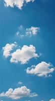 A beautiful display of fluffy white clouds floating across a bright, clear blue sky. photo