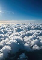 Stunning view of a vast ocean of soft, white clouds floating in the bright blue sky. photo