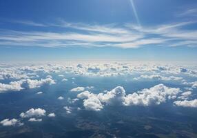 An amazing view of the blue sky filled with white clouds over the land. photo