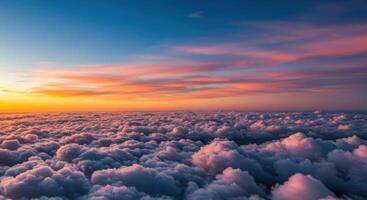 Spectacular sunrise paints the sky above a vast expanse of soft, fluffy clouds. photo