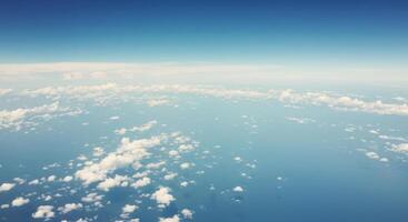 A beautiful aerial view showcasing fluffy clouds floating in a bright blue sky. photo