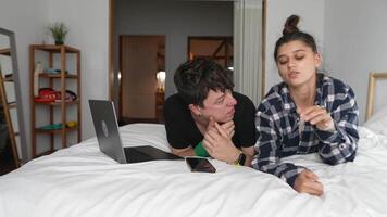 A Couple Happily Enjoying Quality Time Together While Relaxing on Their Bed with a Laptop video