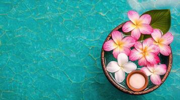 Relaxing Spa Scene Pink and White Plumeria Flowers Floating in Water with Candle photo