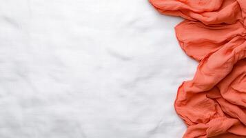 Coral Muslin Fabric Draped on White Textured Background Elegant Soft Texture for Design Projects photo