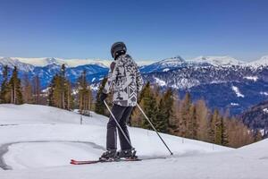 Skier on the mountain slope in Austrian Alps photo