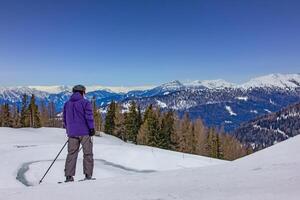 View of the skier on the mountain slopes in Austrian Alps photo