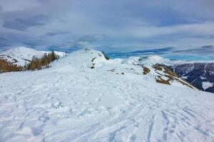 Snow covered mountains under cloudy sky photo