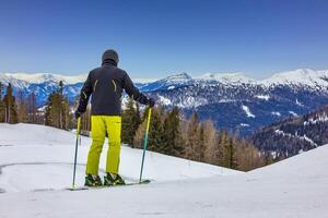 View of the skier on the mountain slopes photo