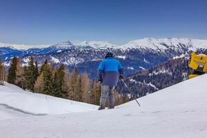 Active skier on the mountain slopes in Austrian Alps photo