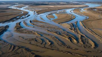 Aerial view of intricate river delta showcasing sediment patterns and water flow photo