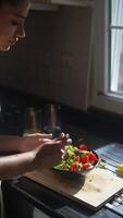 Engaging in the preparation of a healthy salad within a bright and cheerful kitchen setting video