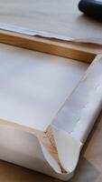 Vertical . Canvas print. Process of stretching canvas on stretcher frame. video
