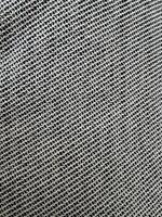 Textured gray fabric showing intricate woven patterns under natural light conditions photo