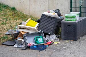 View of various discarded garbage on the street. Garbage on a city street photo