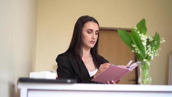Businesswoman reading a notebook in an office setting with a focus on strategy and core values video