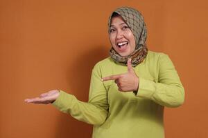 Smiling woman pointing at copy space, great for promo, ads, product mockups, digital marketing visuals, and social campaign concepts with authentic expression photo