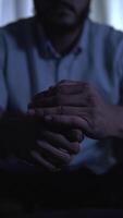 Man clasping hands in increasing despair video