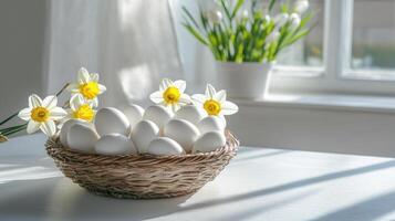 Bright and airy table with a basket of white eggs and scattered daffodils in sunlight. Copy space photo