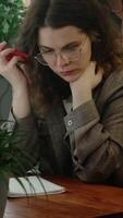 Vertical . Remote work. Upset and disappointed freelance employee listens to voice message with edits and feedback from client. video
