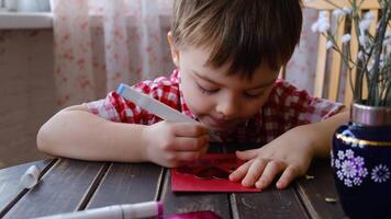 Small child creating handmade greeting card for Mother's Day. video