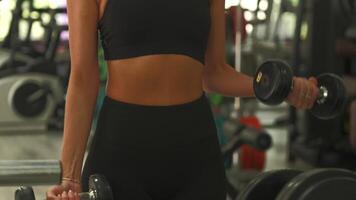 Close-up of dumbbell bicep curl highlighting arm strength and form in gym video