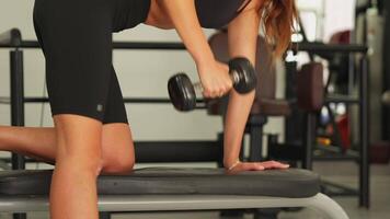 Close-up of back weightlifting exercise on bench in gym, no face visible video