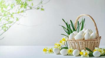 Bright and airy table setting with scattered daffodils and egg-filled wicker basket, symbolizing spring and renewal. Copy space photo