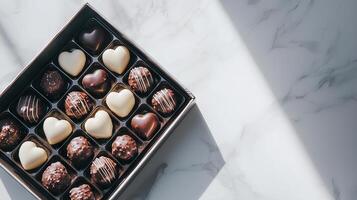 Assorted Chocolates in Heart Shapes on Marble Surface, Sweet Indulgence, Elegant Gift, Romantic Gesture, Gourmet Delight for Special Occasions photo