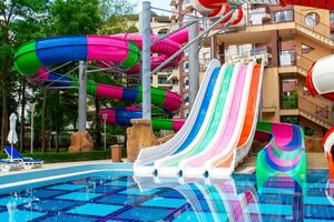 A colorful water slide in a pool with a colorful slide photo