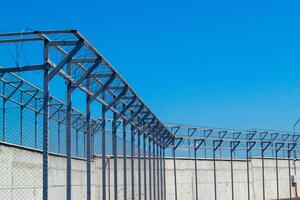 A fence with a blue sky in the background photo
