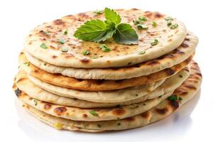 fluffy naan flatbreads stacked high, garnished with cilantro leaves, isolated on a plain white background photo