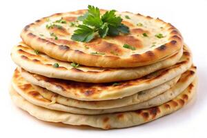 Freshly baked naan flatbreads stacked with a touch of green herbs, perfect for showcasing in culinary photography photo