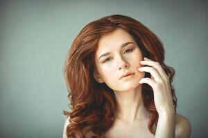 Beautiful young redhead woman with freckles portrait, vintage photo