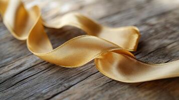 Macro view of smooth yellow fabric ribbon, symbolizing awareness and support for children with cancer. photo
