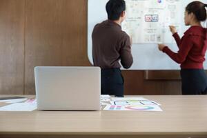 Design Planning Session. Team strategizes on UX UI design with laptops and sketches. photo