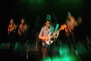 Band performs energetic live music on stage with dynamic lighting effects photo