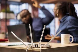Irritated African American man struggling to reach the internet provider to help fix the signal loss issues, freelancers working at home with an unstable Wi Fi connection. Troubleshooting. photo