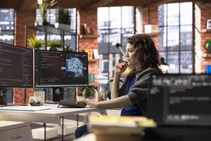 Admin writing code on PC and doing maintenance on artificial intelligence neural networks computerized model. Woman tech support expert doing checkup on AI systems, data science. photo
