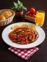 Delicious chicken fajitas served with fresh vegetables and citrus on a rustic table photo