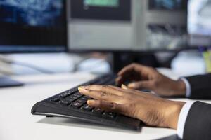 Photovoltaics factory engineer programming AI tools, typing on keyboard, developing solutions to detect errors. Close up of expert writing code, using machine learning to prevent equipment failures photo