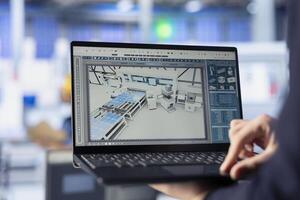 Solar panels manufacturing plant worker developing new photovoltaic materials and technologies using laptop. Close up of photovoltaics factory specialist conducting experiments on notebook photo