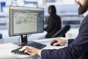 Manager at work in photovoltaics factory office analyzing data, reviewing system metrics. Man in eco friendly solar panels plant producing renewable energy troubleshooting technical issues, close up photo