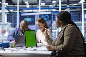Shareholders use mockup device to project returns, assessing deal feasibility. Accountant in office using isolated screen tablet, performing financial analysis for interested investors photo
