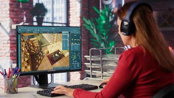 Professional architectural designer configures a floor plan on dual monitors, utilizing computer aided design tools. Woman uses digital rendering and interior decoration remodeling. Camera A. photo