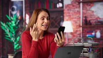 Mature woman engaging in virtual workshop to learn new skills for job, interacting with the coach. Ambitious person joining interactive web learning session for personal development. Camera A. photo