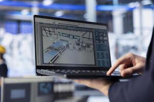 Solar panels plant worker analyzing performance data on laptop and optimizing efficiency. Close up of photovoltaics factory engineer working on innovative solar cells design prototype using notebook photo