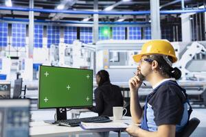 Technician in photovoltaics factory using green screen PC to improve solar panels assembly processes. Engineer using mockup computer to calibrate equipment for precise solar cells manufacturing photo