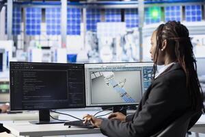 Programmer typing code on PC in photovoltaics production facility, building software tools. Industrial specialist developing automation routines on computer to enhance system efficiency photo