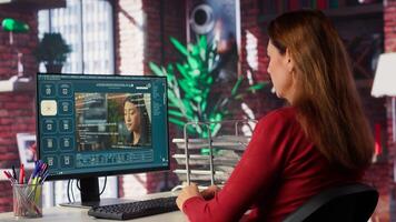 Technician employs AI chatbot on pc monitor and executing programming code. IT freelance expert using coding software and artificial intelligence to write and test code in her apartment. Camera A. photo
