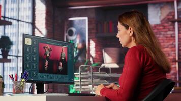 Woman expert developer works with photo editing software in her loft, digital media. Using dual monitors to ensure productivity and innovation in the graphic design world. Camera A.